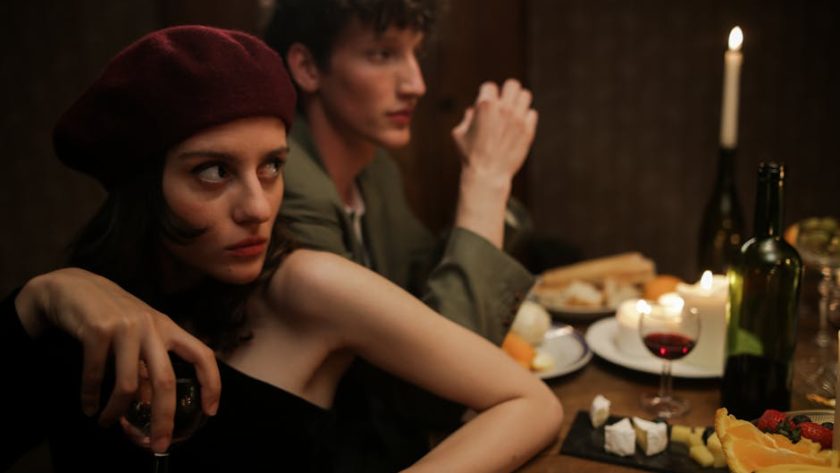 A romantic candlelit dinner with a couple enjoying a cozy evening. Parisian vibes and intimate setting.